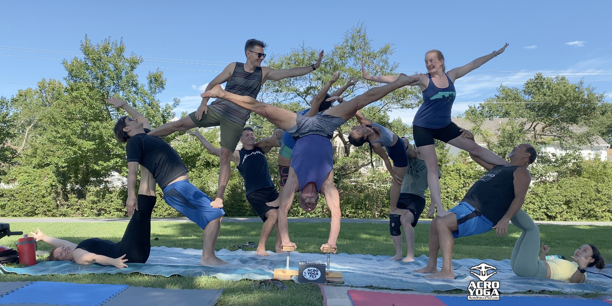 The theme of Acroyoga and Yoga Poses. A pair of two men and a woman stand